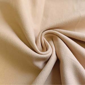 Brushed Cotton Fabric Close-Up A close-up view of soft brushed cotton fabric, showcasing its smooth texture and subtle creases. Perfect for cozy, high-quality apparel.