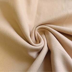 Brushed Cotton Fabric Close-Up A close-up view of soft brushed cotton fabric, showcasing its smooth texture and subtle creases. Perfect for cozy, high-quality apparel.