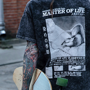 Close-up of black acid-washed t-shirt with Japanese graphic back print, skate culture fashion trend 2025