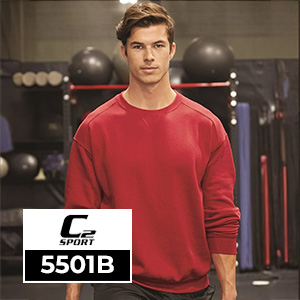 A young man wearing a red C2 Sport 5501B crewneck sweatshirt inside a fitness studio, designed for affordable wholesale team apparel and custom decoration.