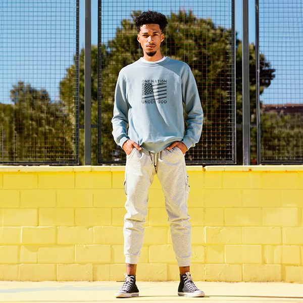 man wearing light blue crewneck sweatshirt casual streetwear outfit outdoors