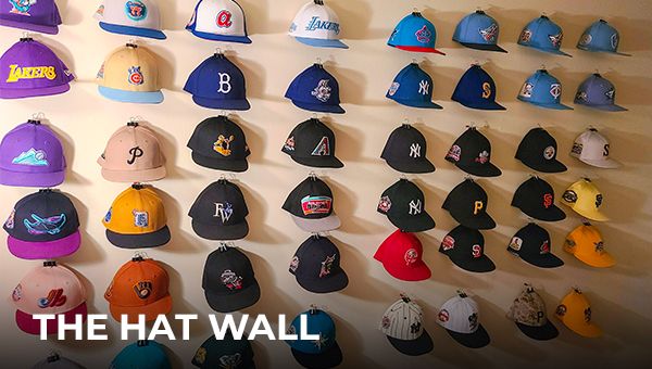 Creating the perfect hat wall display Display of various hats neatly arranged on a wall, showcasing a wide selection for customers