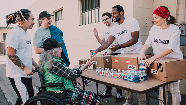 Community Food Donation – Volunteers Supporting People in Need volunteers distributing food and supplies to people in need community support and charity aid