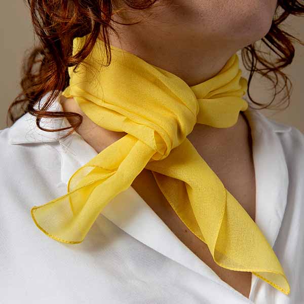 woman wearing yellow lightweight scarf tied around neck stylish fashion accessory